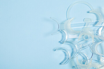 set of several Retractor Dental lip retractor Access to the oral cavity. Wide mouth opening for a dental procedure on a clean blue background