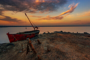 Old boat on the lake, sunset. soft focus