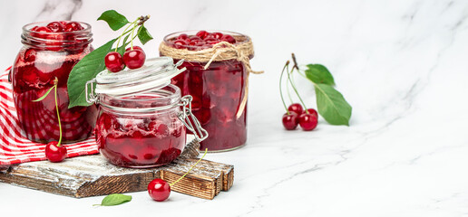 Berries cherry with syrup. Berries cherry with syrup. Canned fruit on a light background. Long banner format
