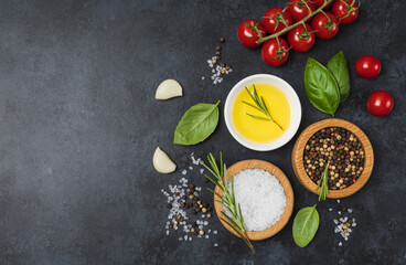 Food background from vegetable, spices, herb on black table.