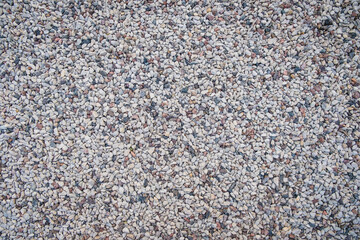 Mixed small gray broken rocks, loose gravel, road construction. Limestone aggregate. Crushed stone background