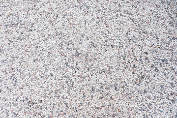 Mixed small gray broken rocks, loose gravel, road construction. Limestone aggregate. Crushed stone background