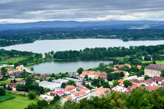 Aerial view from the edge of a village in front of two lakes with the mountains of the Bohemian Massif in the background