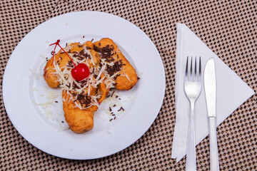 traditional food (odading) mixed with cheese, chocolate and cherries on top