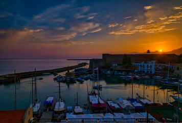 Fototapeta na wymiar Sunrise and sunset in Kyrenia harbor. Cyprus Turkiyr Kyrenia castle.
