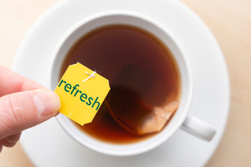 Top down view of cup of tea with the word 'refresh'