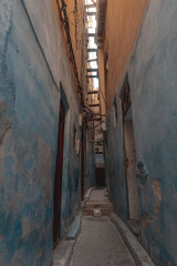 Fototapeta na wymiar Empty narrow street in the old medina of Fes