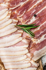 Bacon slices. Pork belly with rosemary, Keto diet food ingredients. Food recipe background. Close up