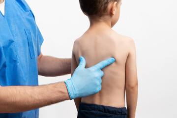 Male doctor examins little's boy body by making a routine checkup. Health care concept.