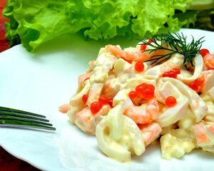 Royal salad with red caviar, shrimp and squid.