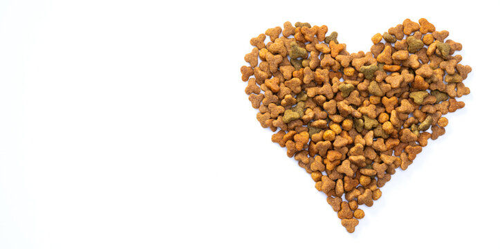 Valentines Day And Love Of Pets Concept. Heart Shaped Cat Dry Kibble Food On White Background