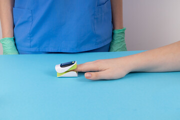 Doctor measure blood oxygen patient with oximeter. Doctor and patient. Revealing Omicron Ba.4 - Ba.5