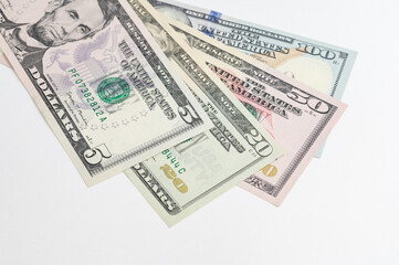 5, 20, 50, 100 dollars banknotes at different angles. Close up of dollars on white background.