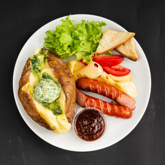 baked potato with sausage and salad
