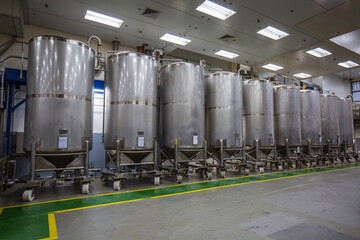 Stainless vertical steel tanks with pressure meter in equipment tank chemical cellar at the with...