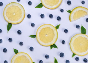 background of blueberries and lemon slices on a white background - the concept of a healthy diet....