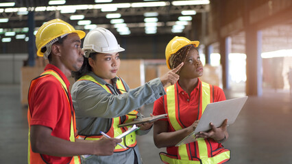 Team of professional engineers or foreman working and discussing together in the factory.