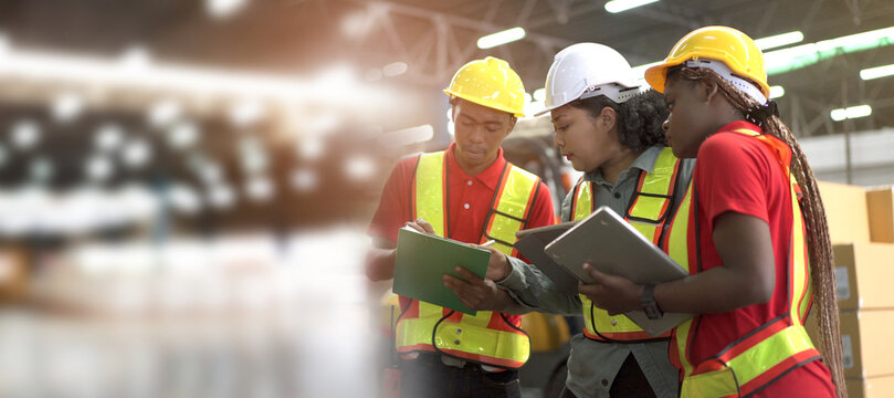 Team of professional engineers or foreman working and discussing together in the factory.