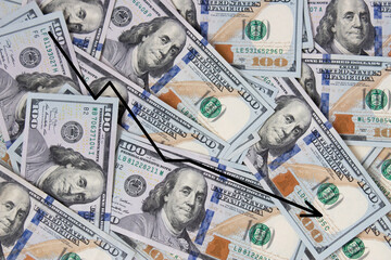Background of hundred-dollar bills with a graph of the fall. The texture of hundred-dollar bills. A lot of dollars