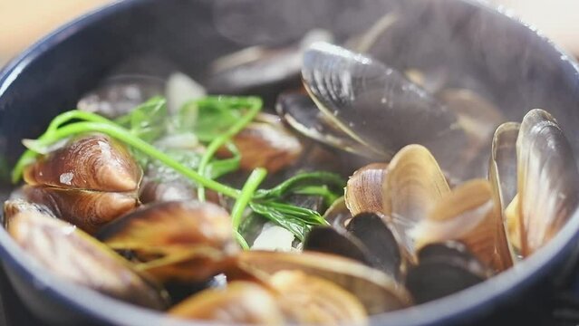 Preparation of delicious mussels with white wine in the saucepan.
