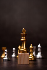 Golden king chess standing on a wooden stand. The concept of Leaders in good organizations must have a vision and can predict business trends and assess competitors