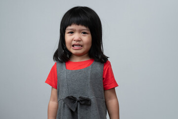 Portrait of Asian angry, sad and cry little girl on white isolated background, The emotion of a...