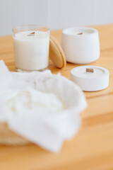 Vertical photo of Handmade Candles from Side. Soy Candle in Glass Holder with Wooden Lid.
