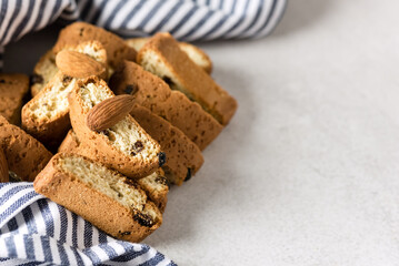 Italian Cantuccini Cookies Sweet Dried Biscuits with Nuts and Raisin Blue Napkin Gray Background Copy Space