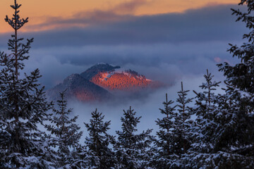 Colorful winter sunset in the Alps, above the inversion and clouds