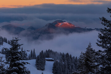 Colorful winter sunset in the Alps, above the inversion and clouds