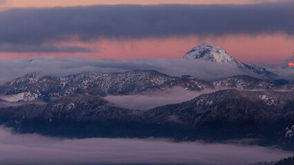 Colorful winter sunset in the Alps, above the inversion and clouds