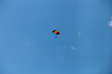 Parasailing in blue sky. Parachute sports, active leisure, travel, vacation concept. Freedom and active lifestyle
