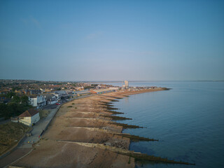 Obraz premium Aerial drone view of whitstable beach groynes hotel harbour and open sea