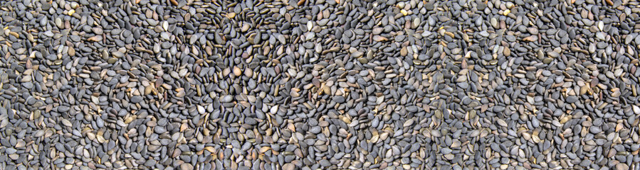 black sesame seeds close up. background with the image of black sesame. Banner for insertion into site.