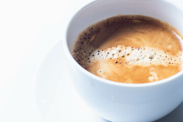 Hot americano coffee in a white cup isolated on a white table.