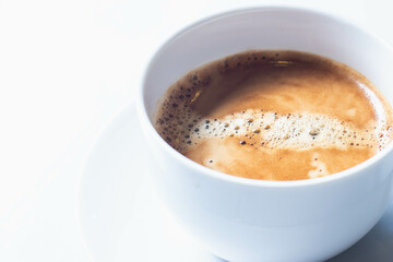 Hot americano coffee in a white cup isolated on a white table.