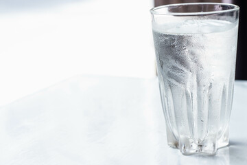 Water glass with some ice selective focus, blur some part.