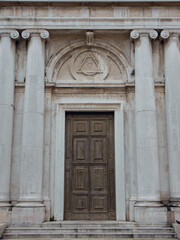 Venetian cathedral with columns and large wooden doors