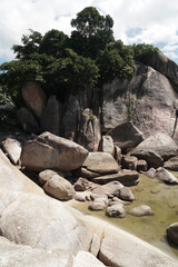 Fototapeta na wymiar Landscape Nature beautiful rock of Hin Ta Hin Yai or Grandfather and Grandmother Rocks is located in Lamai beach Samui island Thailand - Storied natural rock resemblance to male female genitalia.