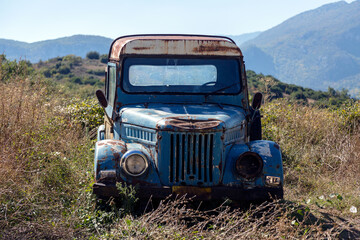 Old rusty blue truck for transporting food or animals in the Greek mountains