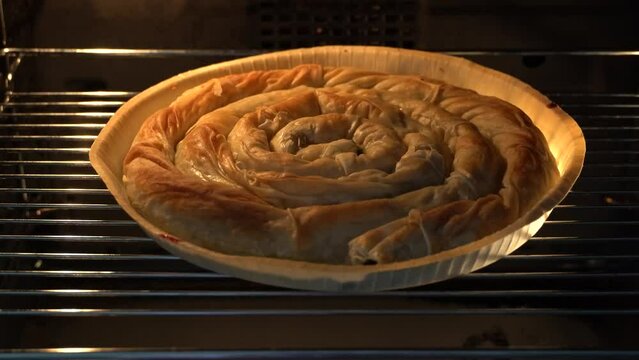 Ready to eat Turkish pastry "Borek" with spinach in an oven  