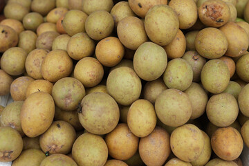 healthy and fresh sapodilla fruit neatly arranged for sale in the market. healthy and fresh fruit...