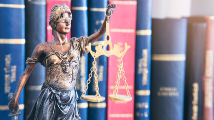 Scales of justice in front of book background