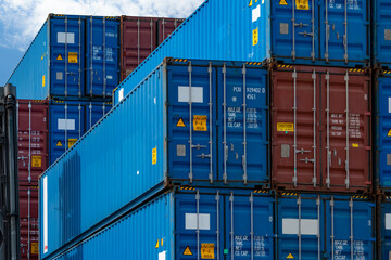 Close-up blue and red logistic container. Cargo and shipping business. Container ship for import...