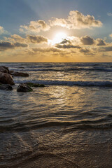 Beautiful summer sunset at the breakwater on the Mediterranean Sea. Israel.