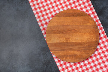 Wooden cutting board and spices, herb for food on black stone table