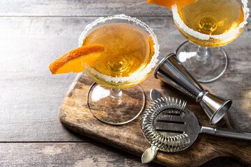 Sidecar cocktail with a sugar rim on wooden table