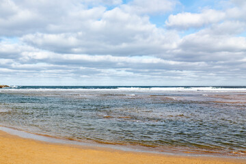 Views of a beach and a coastal city in the background. Concept travel