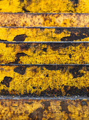 Abstract rusty metal stairs in yellow paint, aged metal stairs