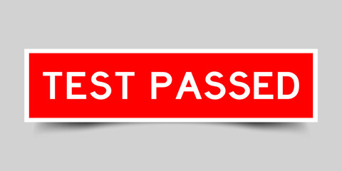 Red color square shape sticker label with word test passed on gray background